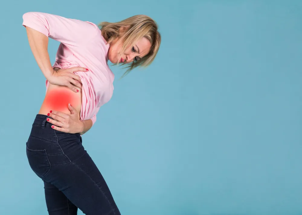 Woman holding her side and lower back from hip pain