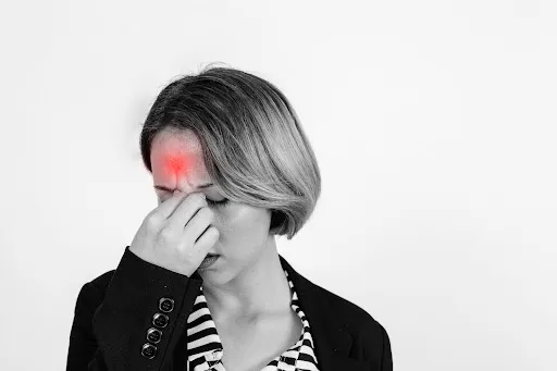 Woman pressing her forehead during a headache