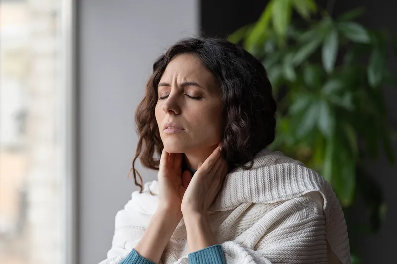 Woman holding her neck due to pain