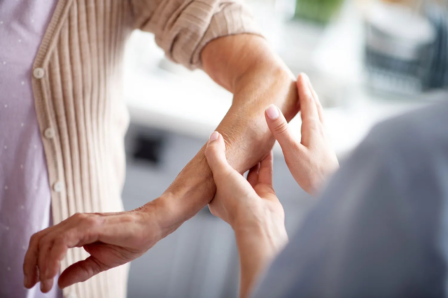 medical practitioner checking arm pain on patient