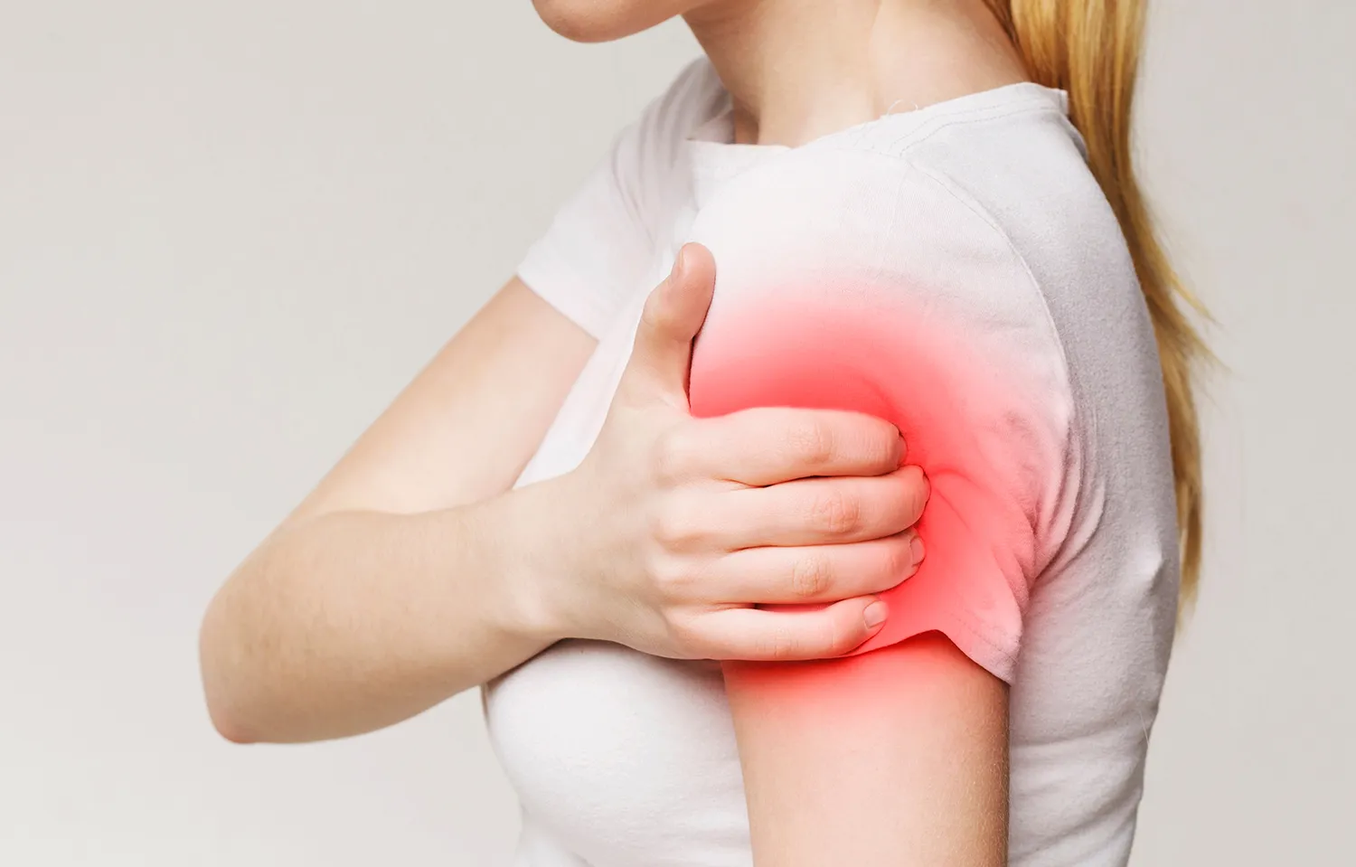 woman holding her arms due to pain
