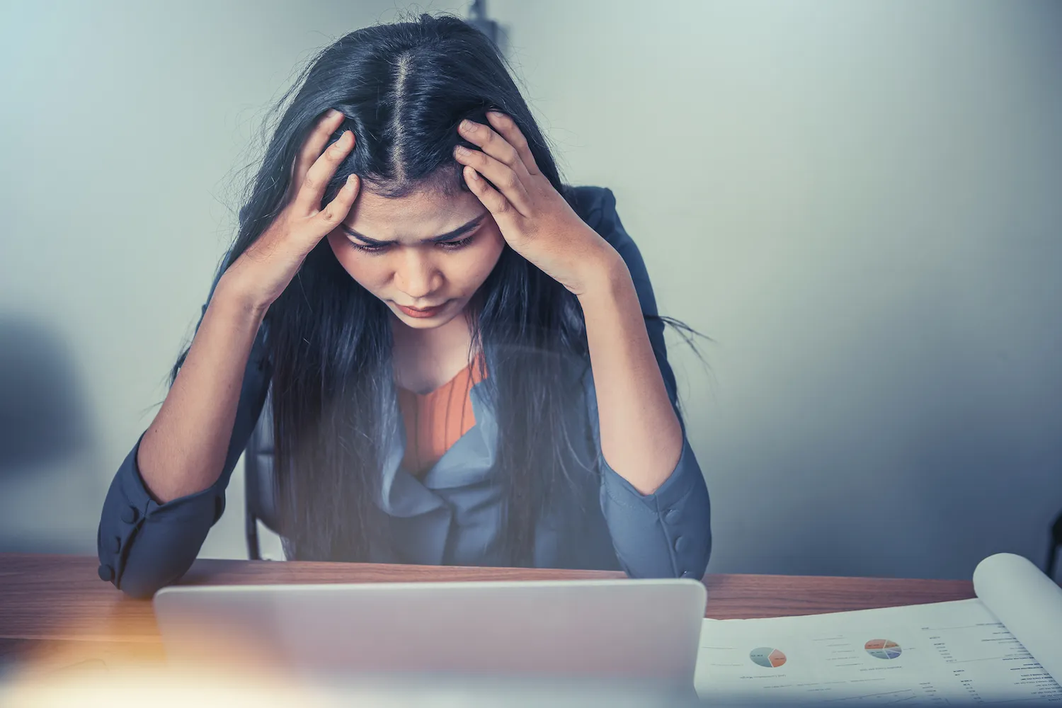 young woman suffer from migraine while on work